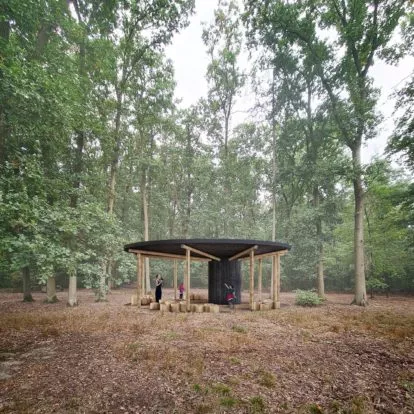 Pohled na lesní pavilon, pod vysokými stromy